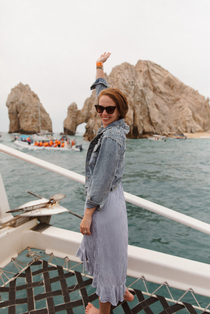 The bride on a whale watching boat excursion, the day after her wedding in Cabo San Lucas. Adding a fun experience to her destination wedding weekend, complete with a photographer.